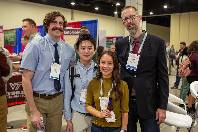 smiling group of 4 people at conference