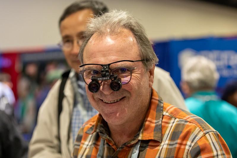 smiling man with glass magnifying