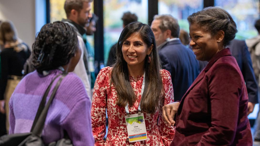 Annual meeting attendees talking in the hallway